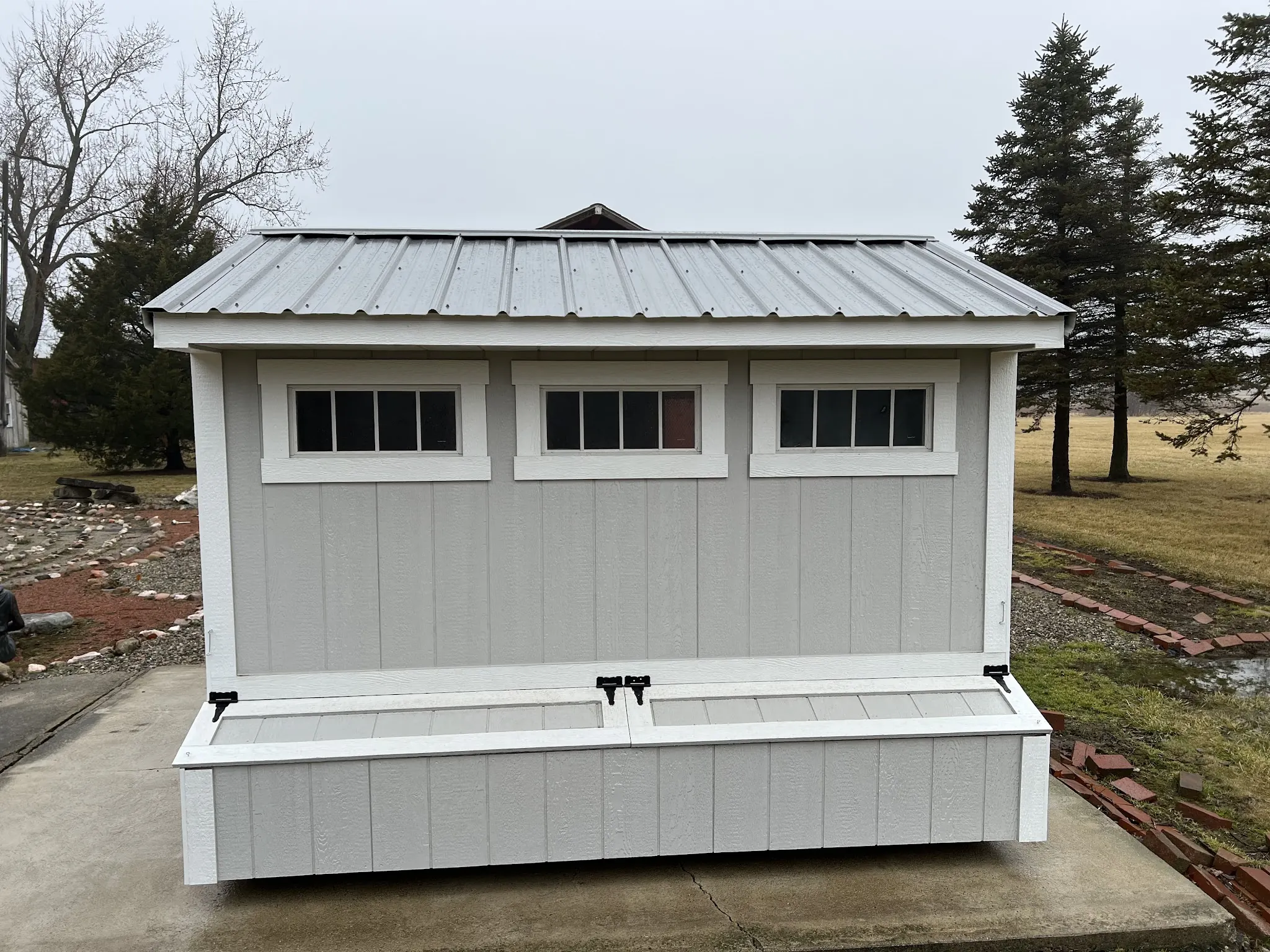 White studio building with a row of transom windows