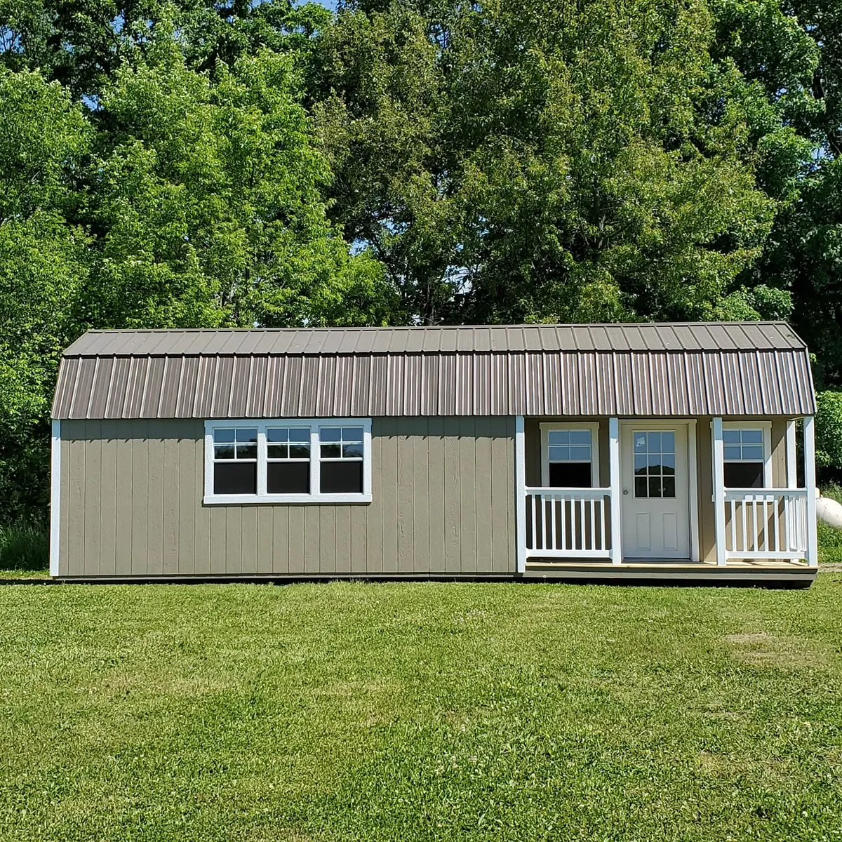 Tan casita-style cottage shed on lawn