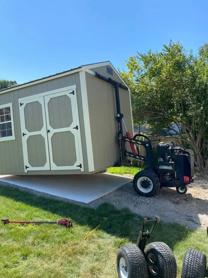 Sage green shed, white trim, double doors and windows, gray roof